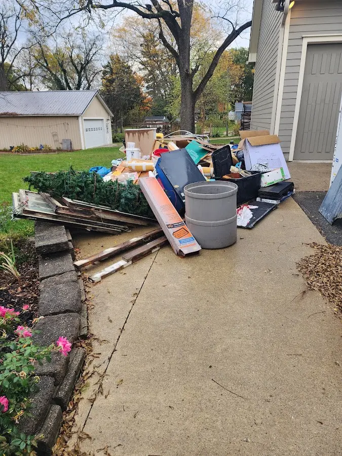 Dumpster being loaded with debris for Estate Cleanout Dumpster Rental in Glencoe